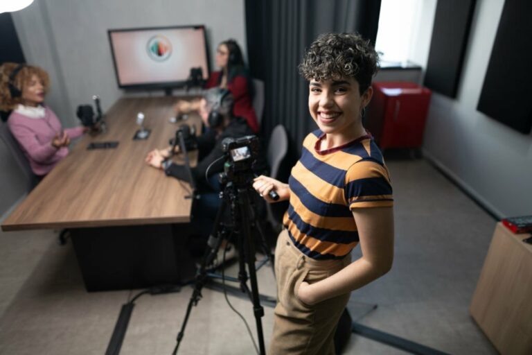 Portrait of a videographer woman holding tripod at podcast studio